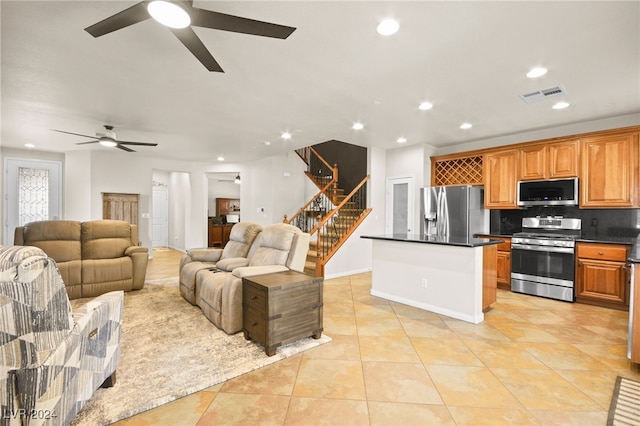 living room with ceiling fan and light tile patterned flooring