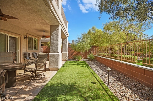 view of yard with ceiling fan