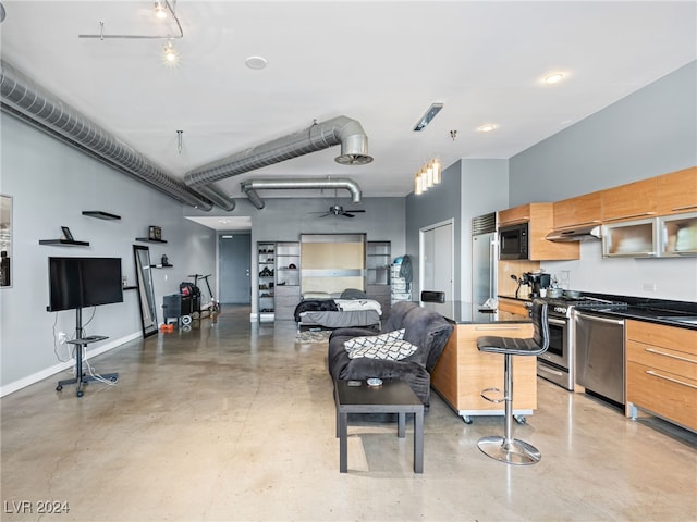 kitchen featuring extractor fan, a breakfast bar, decorative light fixtures, and stainless steel appliances