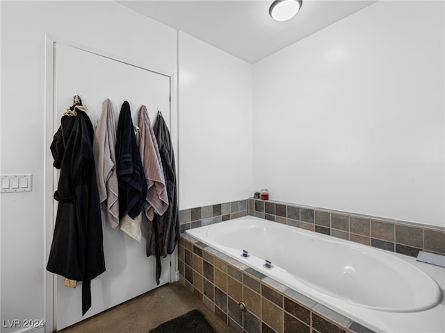 bathroom with a relaxing tiled tub