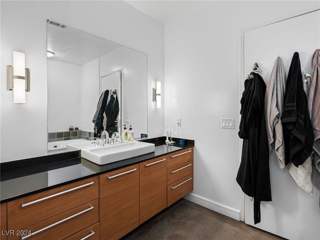 bathroom with vanity and concrete flooring