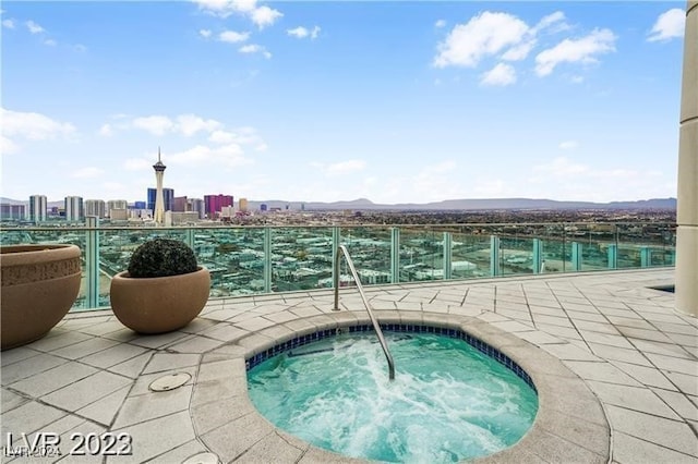 view of swimming pool featuring an in ground hot tub and a mountain view