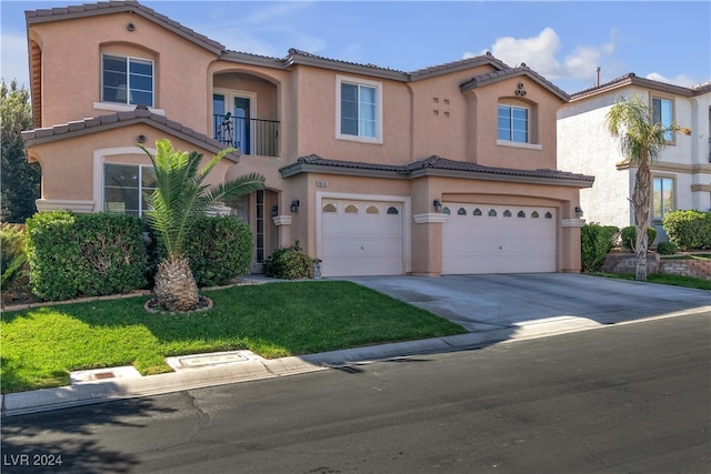 mediterranean / spanish-style house with a front yard, a garage, and a balcony