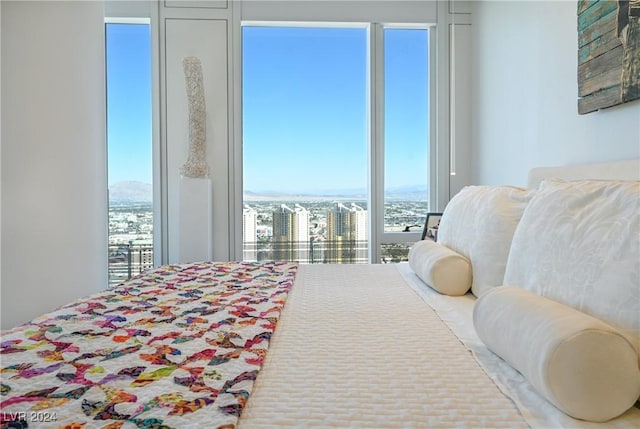 bedroom with a view of city