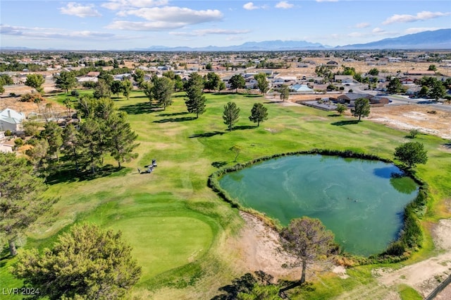 birds eye view of property with a water and mountain view