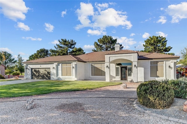 view of front of property with a garage and a front lawn