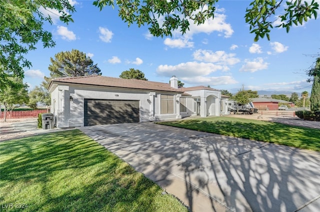 view of front of home featuring a front yard and a garage