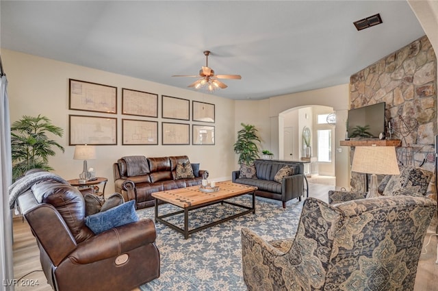 living room featuring light hardwood / wood-style floors and ceiling fan