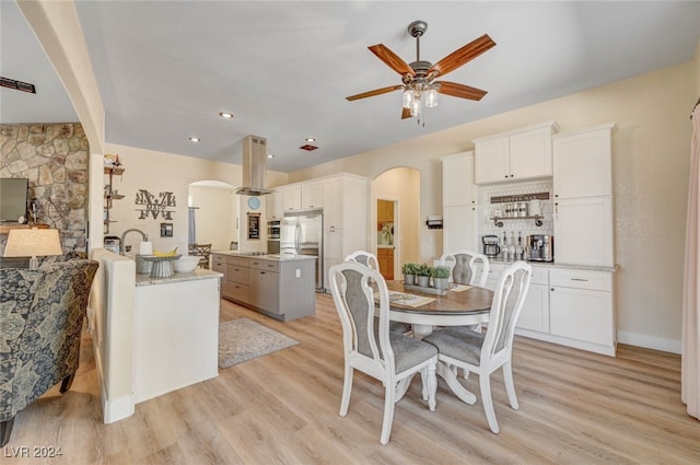 dining area featuring ceiling fan and light wood-type flooring