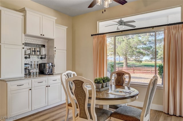 dining space featuring light hardwood / wood-style flooring, a wealth of natural light, and ceiling fan