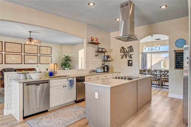 kitchen with sink, dishwasher, island range hood, white cabinets, and light stone counters