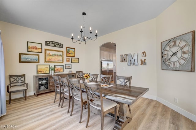 dining room featuring a chandelier and light wood-type flooring