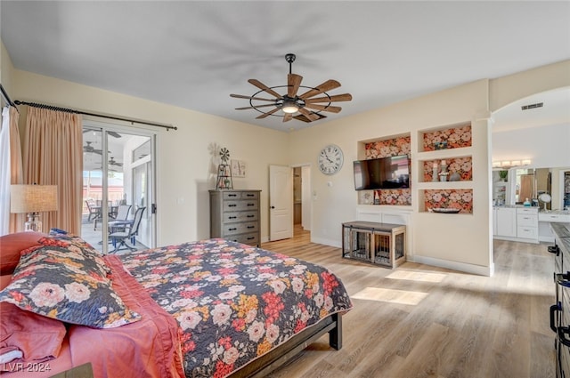 bedroom featuring light hardwood / wood-style floors, ensuite bathroom, access to exterior, and ceiling fan