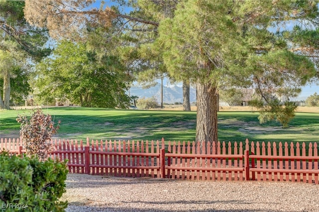 surrounding community featuring a mountain view and a lawn