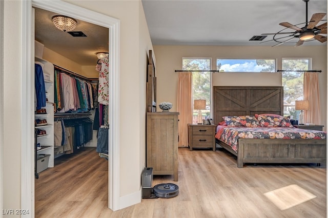 bedroom with light wood-type flooring and ceiling fan