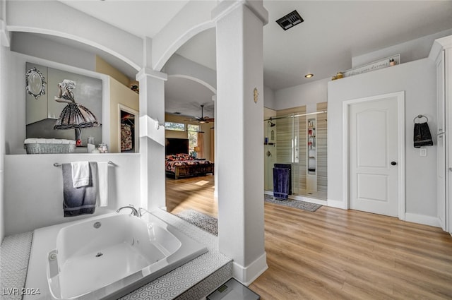 bathroom featuring separate shower and tub, hardwood / wood-style floors, and ceiling fan