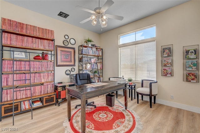 home office featuring light hardwood / wood-style floors and ceiling fan