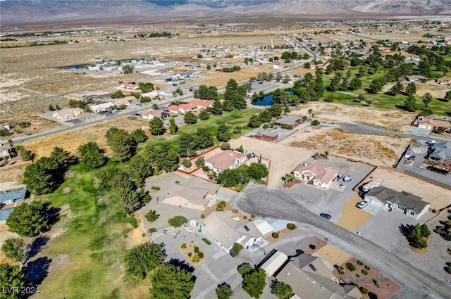 birds eye view of property with a mountain view