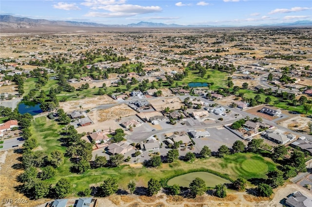 birds eye view of property with a water and mountain view