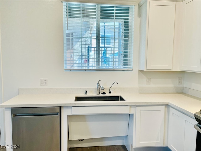 kitchen featuring dishwasher, white cabinetry, dark hardwood / wood-style flooring, and sink