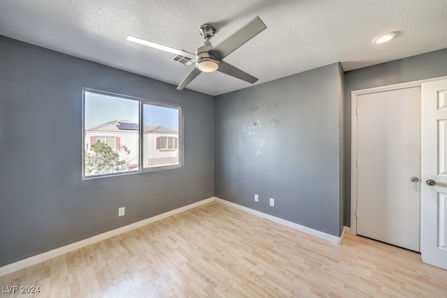 unfurnished bedroom featuring light hardwood / wood-style floors, a textured ceiling, and ceiling fan