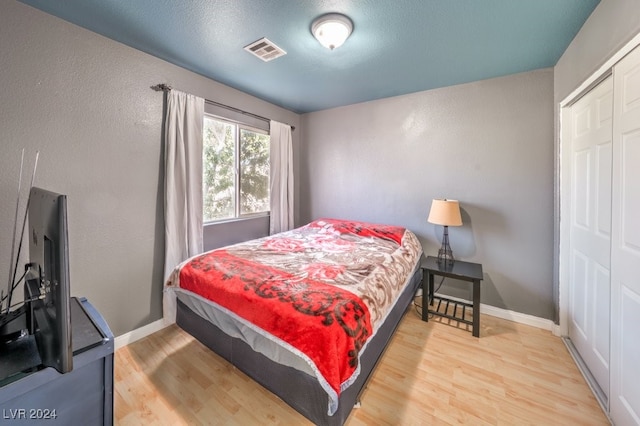 bedroom featuring a closet and wood-type flooring