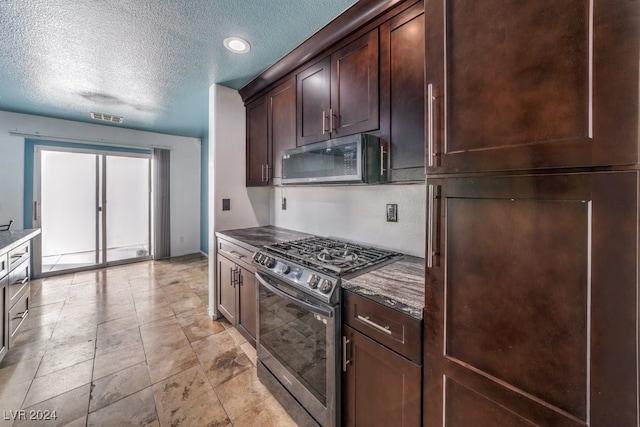 kitchen with a textured ceiling, dark brown cabinetry, and stainless steel appliances