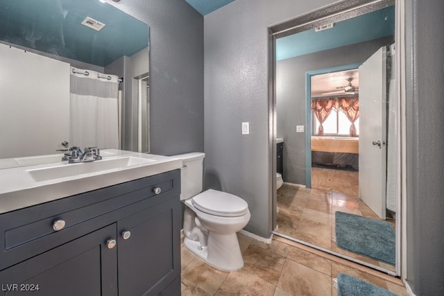 bathroom with vanity, toilet, a shower with curtain, and tile patterned flooring