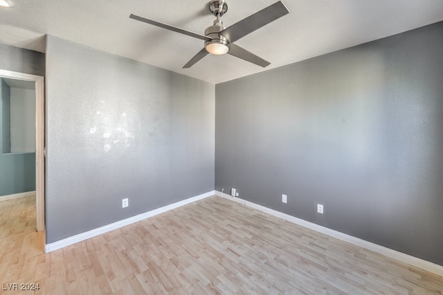 spare room featuring light hardwood / wood-style floors and ceiling fan