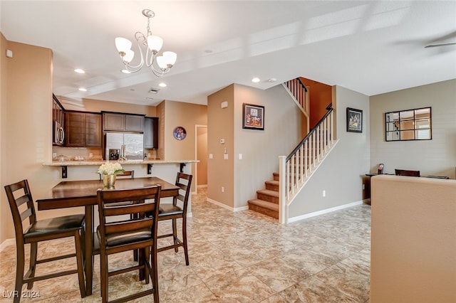 dining area featuring a notable chandelier