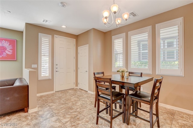 dining room with a chandelier and a healthy amount of sunlight