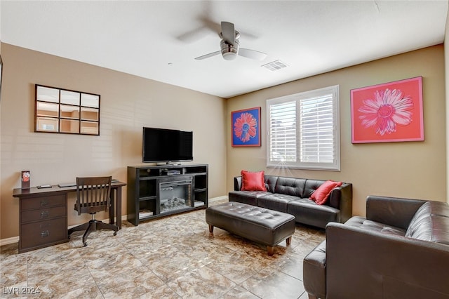 living room featuring a fireplace and ceiling fan