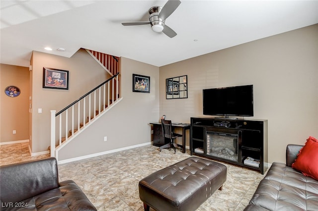 living room with a fireplace and ceiling fan