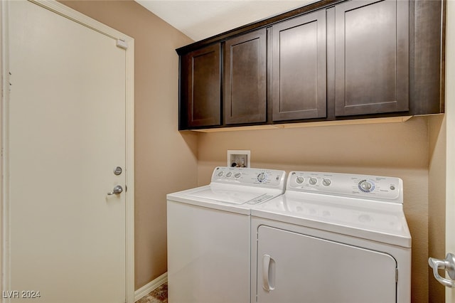 washroom with cabinets and washer and clothes dryer