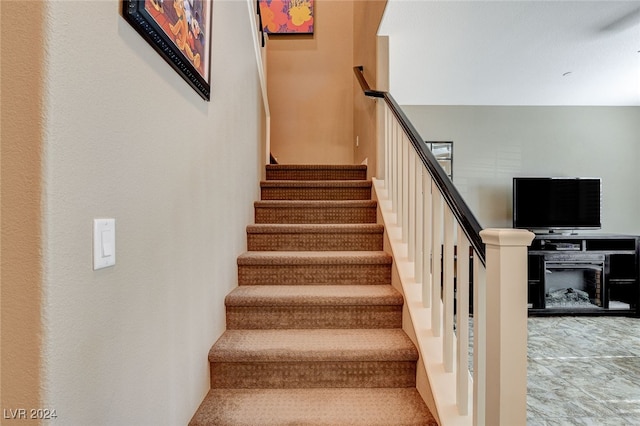 stairs featuring a fireplace