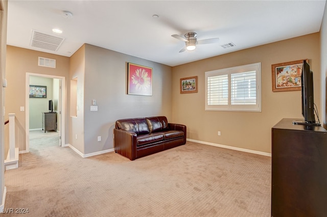 living area featuring ceiling fan and light colored carpet