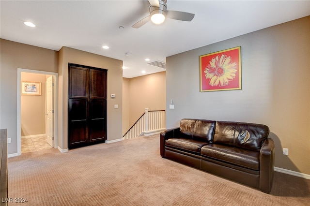 carpeted living room with ceiling fan