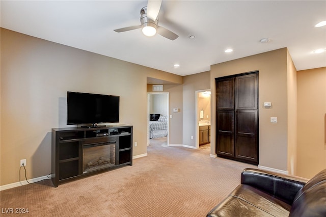 carpeted living room with ceiling fan