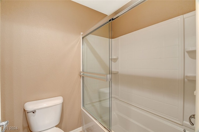 bathroom featuring shower / bath combination with glass door and toilet