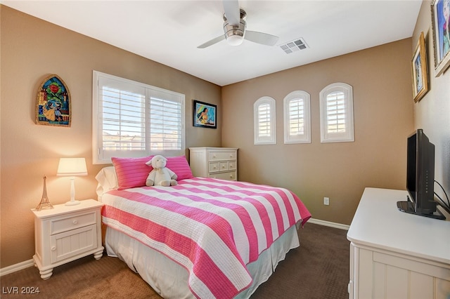 bedroom with dark colored carpet and ceiling fan