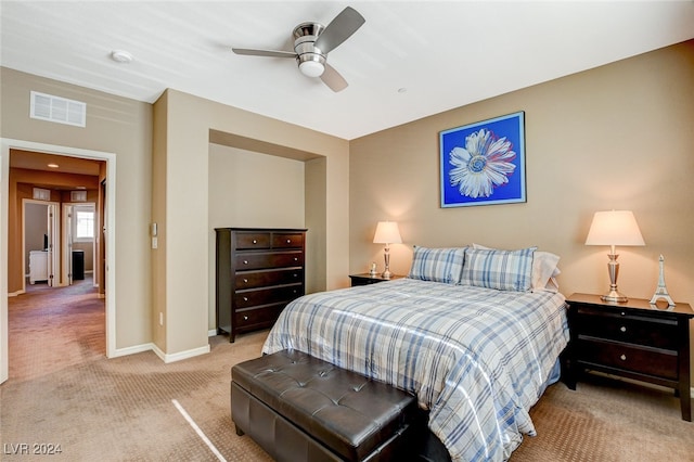 bedroom with ceiling fan and light colored carpet