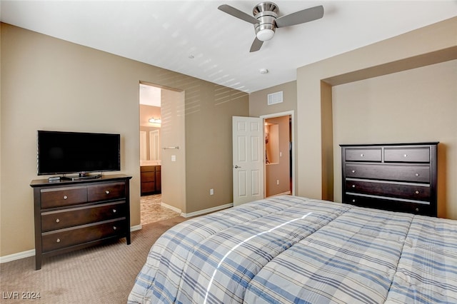 carpeted bedroom featuring ensuite bathroom and ceiling fan