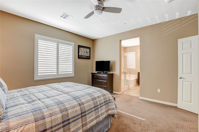 bedroom with ensuite bath, light colored carpet, and ceiling fan