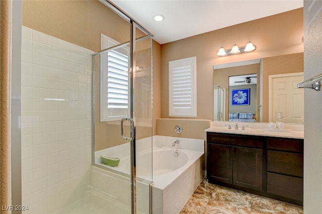 bathroom featuring vanity and shower with separate bathtub