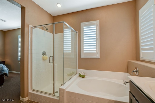 bathroom featuring vanity and separate shower and tub