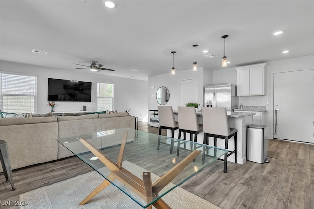 dining area featuring ceiling fan, light hardwood / wood-style floors, and plenty of natural light