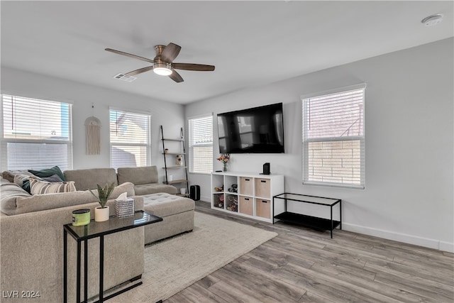 living room featuring light hardwood / wood-style floors and ceiling fan