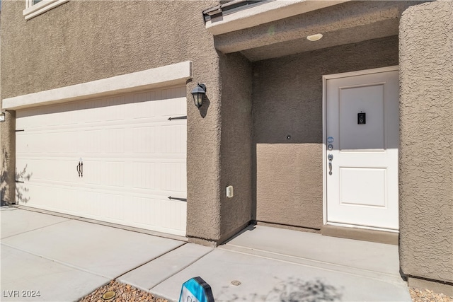 view of exterior entry with a garage