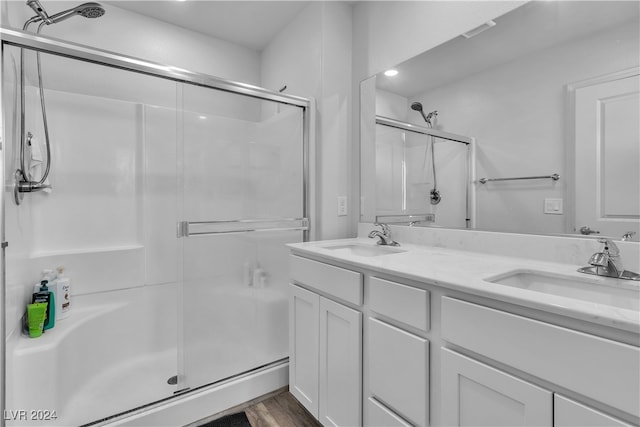 bathroom featuring vanity, an enclosed shower, and hardwood / wood-style floors