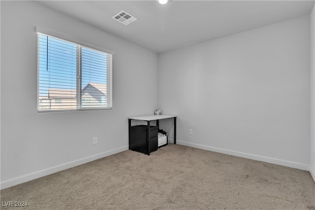 unfurnished room with light colored carpet